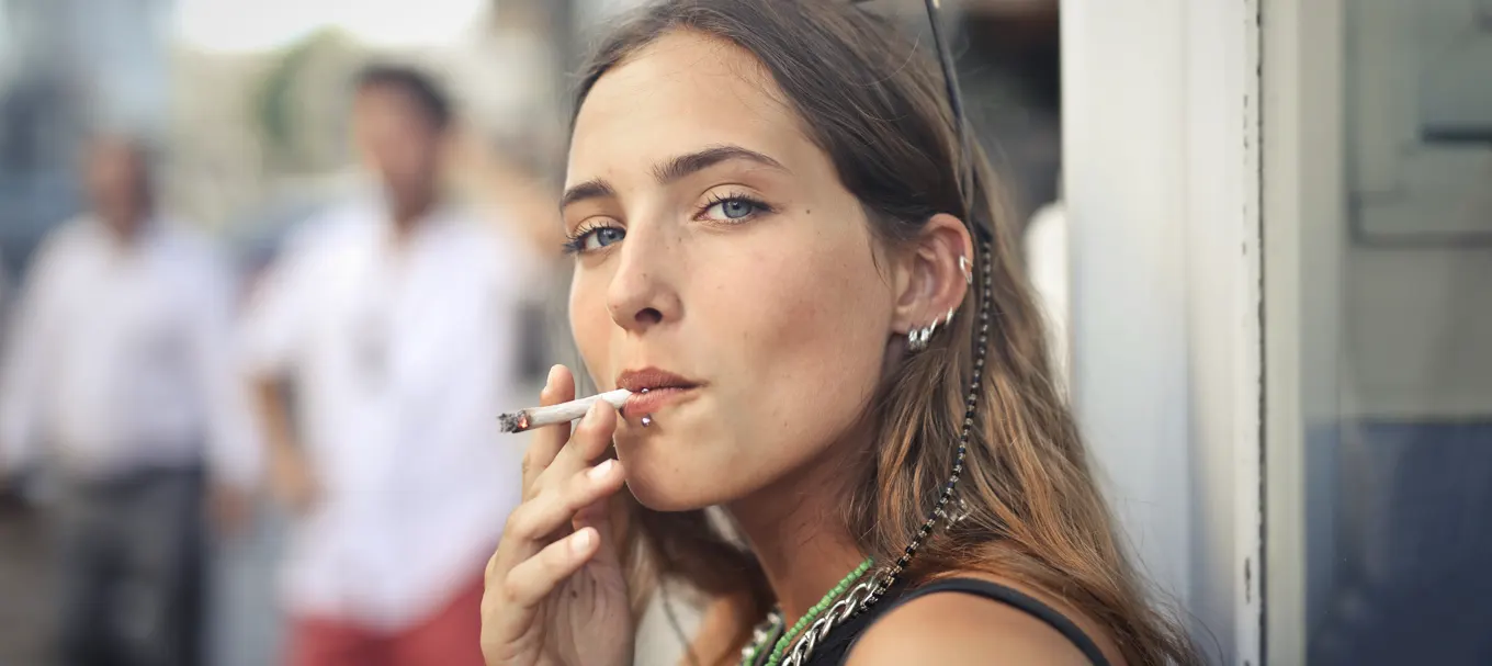 portrait-young-female-smoking-street
